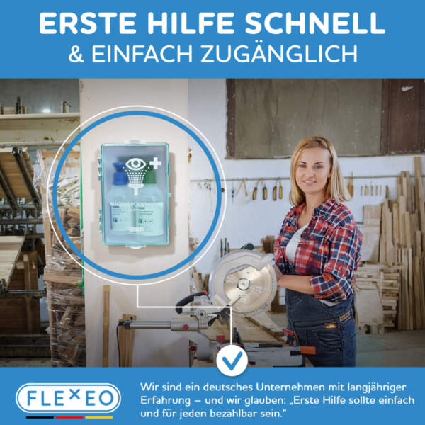 Augenspülstation montiert an einem pfeiler in einer werkstatt, daneben steht eine handwerkerin und sägt